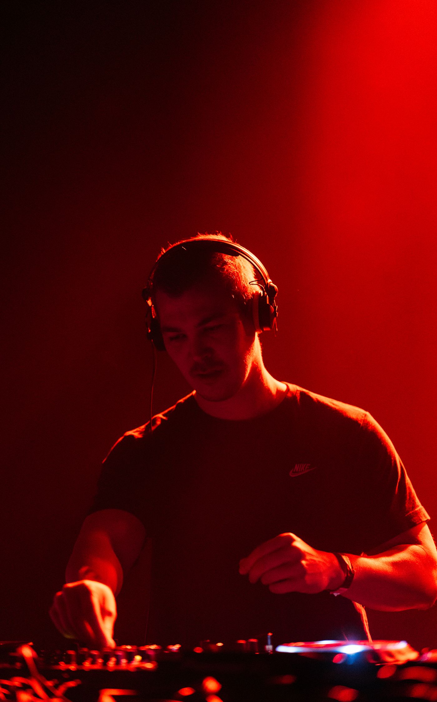 Sander Chan behind the decks in red light